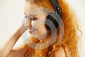 Beautiful young redhead with headphones