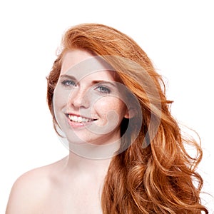 Beautiful young redhead woman with freckles portrait