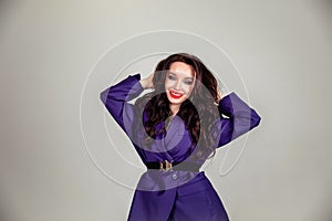 Beautiful young Russian model girl in retro clothes, she is dressed in a large male purple jacket