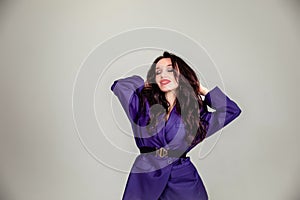 Beautiful young Russian model girl in retro clothes, she is dressed in a large male purple jacket