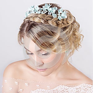 Beautiful young elegant sweet girl in the image of a bride with hair and flowers in her hair , delicate wedding makeup