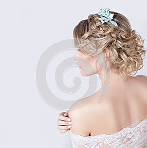 Beautiful young elegant sweet girl in the image of a bride with hair and flowers in her hair , delicate wedding makeup