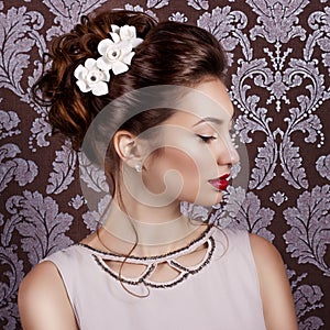 Beautiful young sweet girl with large red lips in wedding white wreath on the head
