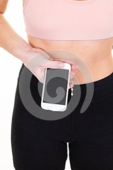 Beautiful young slim sports woman make fitness exercises isolated using mobile phone showing blank screen smartphone