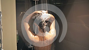 Beautiful Young Slim Woman Washing Hair in Shower