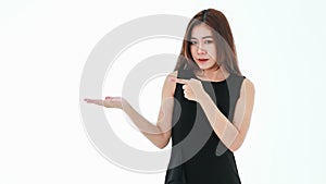 A beautiful young smart businesswoman wearing black dress standing on white background, holding something on the palm of her right