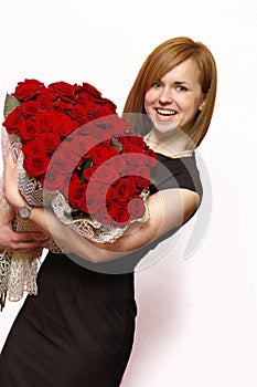 Beautiful young smiling blonde with roses photo