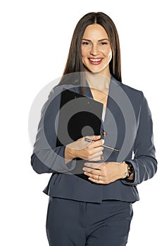 Beautiful young smiling business woman in a pants and jacket with notepad