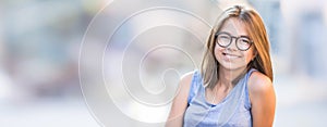 Beautiful young smiling teen girl with glasses.