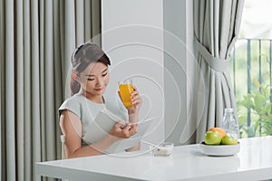 Beautiful young smiling woman having delicious tasty breakfast