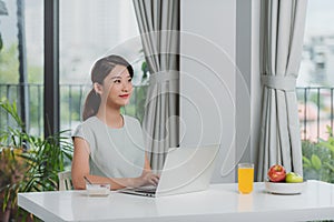 Beautiful young smiling woman having delicious tasty breakfast