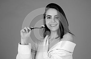 Beautiful young smiling woman with healthy teeth, beautiful female smile. Dental concept. Smiling young woman brushing