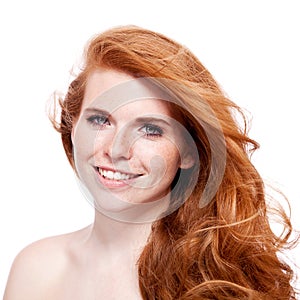 Beautiful young smiling woman with red hair and freckles isolated