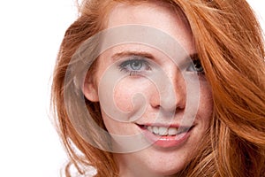 Beautiful young smiling woman with red hair and freckles isolated