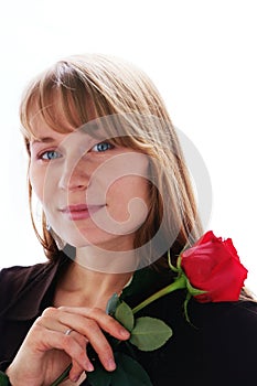 Beautiful young smiling woman with red rose