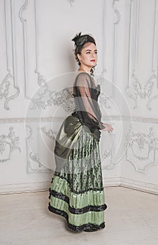 Beautiful young smiling woman wearing green medieval vintageStyle dress