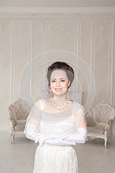Beautiful young smiling woman wearing medieval vintage Edwardian Style dress