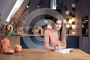 Beautiful young smiling woman working from home