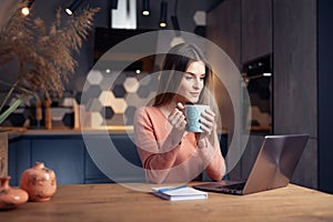 Beautiful young smiling woman working from home