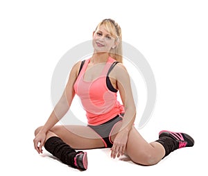 Beautiful young sportswoman doing stretching exercises