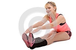 Beautiful young sportswoman doing stretching exercises