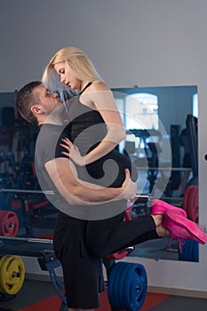 Beautiful young sporty couple in gym