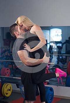 Beautiful young sporty couple in gym