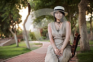 Beautiful young student Asian girl sitting in the park