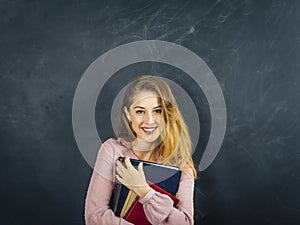 Beautiful young student in front of blackboard