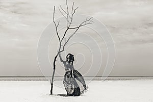 Beautiful young stylish tribal dancer. Woman in oriental costume dancing outdoors