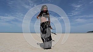 Beautiful young stylish tribal dancer. Woman in oriental costume dancing outdoors