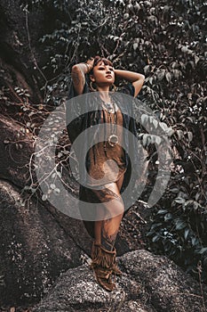 Beautiful young stylish tribal style woman outdoors