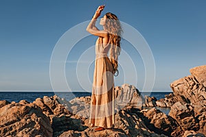 Beautiful young stylish woman on the beach