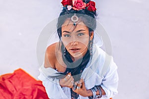 Beautiful young stylish woman on the beach at sunset