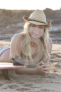 Beautiful Young Surfer girl early at the beach