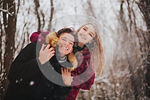 Beautiful young teen couple spending time together outside in cold winter