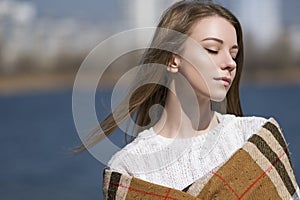 Beautiful young teenage caucasian woman in a plaid walking think