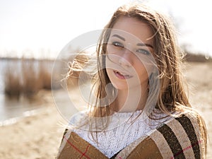 Beautiful young teenage caucasian woman in a plaid walking think