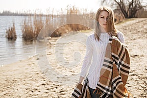 Beautiful young teenage caucasian woman in a plaid walking think