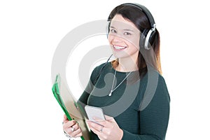 Beautiful young teenage girl in headphones listening to music with coffee tea mug cup standing on white background