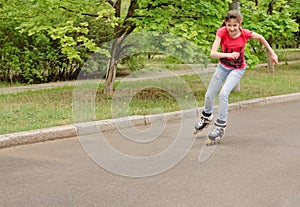 Beautiful young teenage girl roller skating