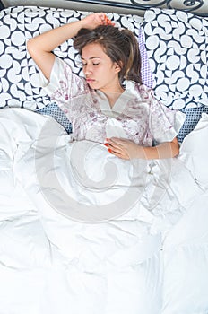 Beautiful young teenage girl sleeping in bed