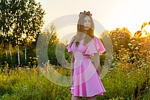 Beautiful young teenager girl in pink dress with crown