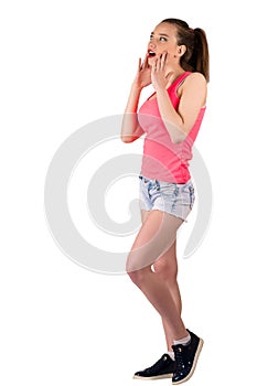 Beautiful young teenager girl standing in full length surprised