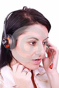 Beautiful young telephonist speaking on a headset photo