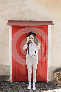 Beautiful young tourist with camera in the old town.