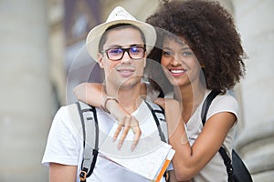 Beautiful young tourist couple posing in city