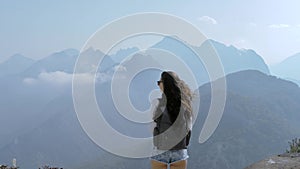 Beautiful young tourist girl with backpack at mountains