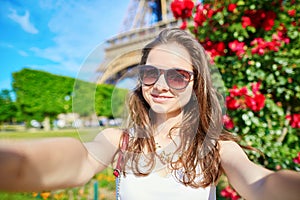 Beautiful young tourist in Paris taking selfie