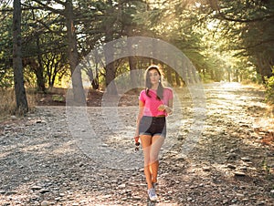 Beautiful young woman in against the sun background